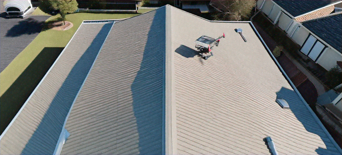 A drone which has landed on top of a modern roof.